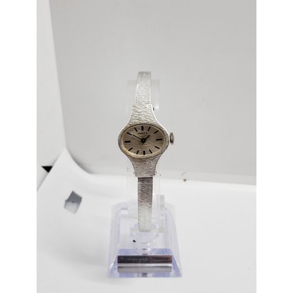 Small women\'s Timex dress watch. Oval Silver opalescent face. Bangle style band main image 6